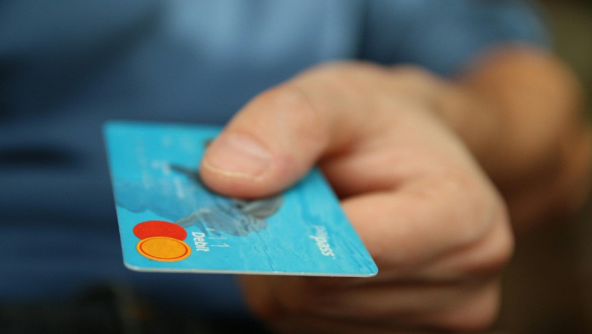 Man holding debit card for online shopping. E-commerce.
