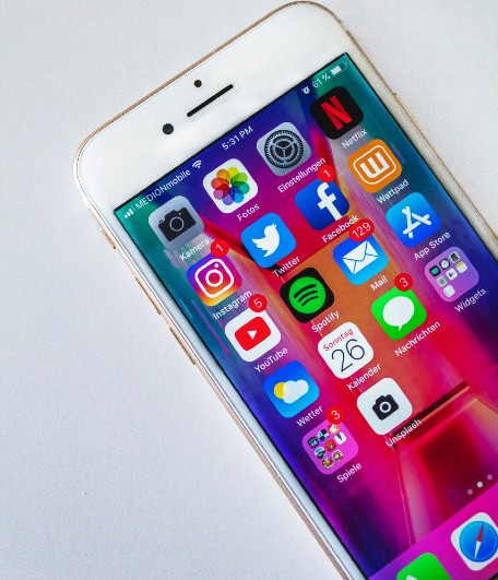 Mobile phone showing social media apps with notifications.